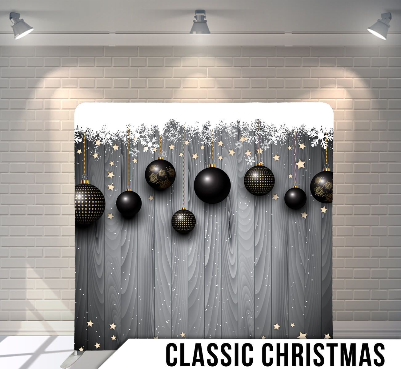 Elegant black Christmas ornaments and silver snowflakes hang against a gray textured backdrop for a classic holiday display.
