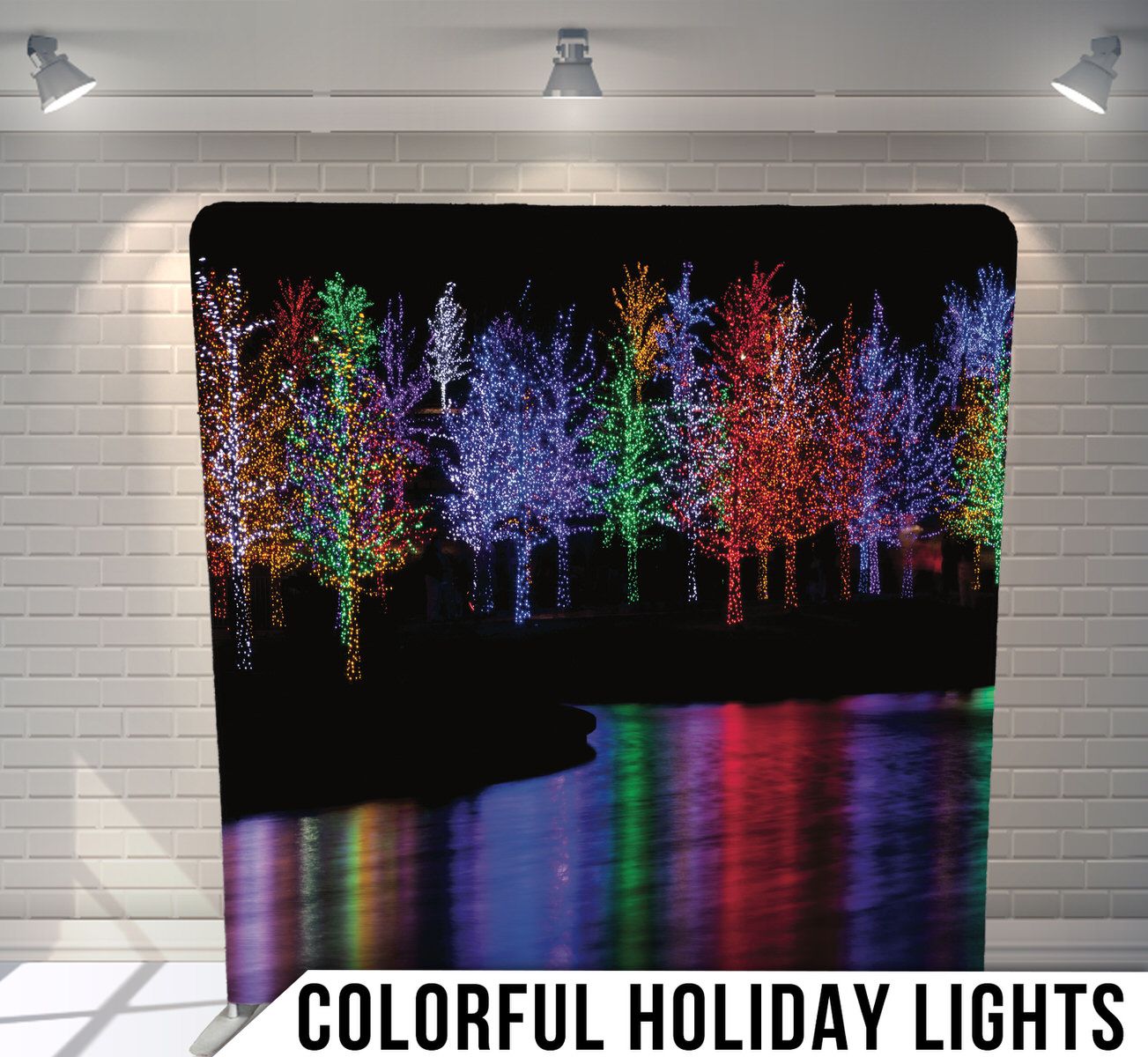 Illuminated trees with colorful LED lights reflecting on water creating a magical nighttime scene.