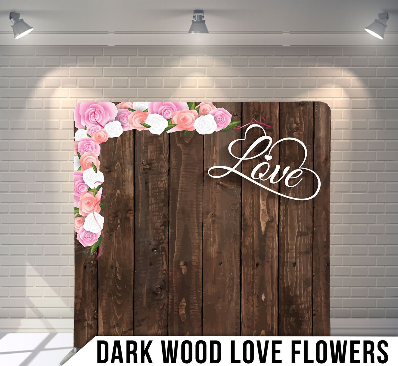 Rustic wood backdrop decorated with pink flowers and cursive 'Love' text against white brick wall.