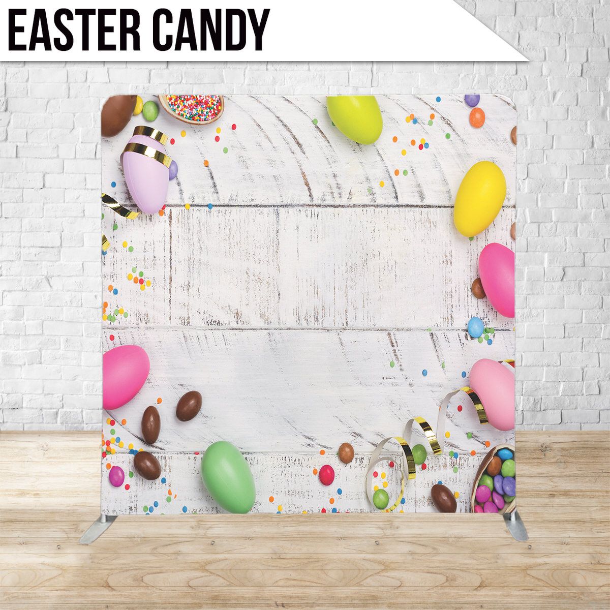 Festive Easter photo backdrop with colorful eggs and candy scattered around white frame.