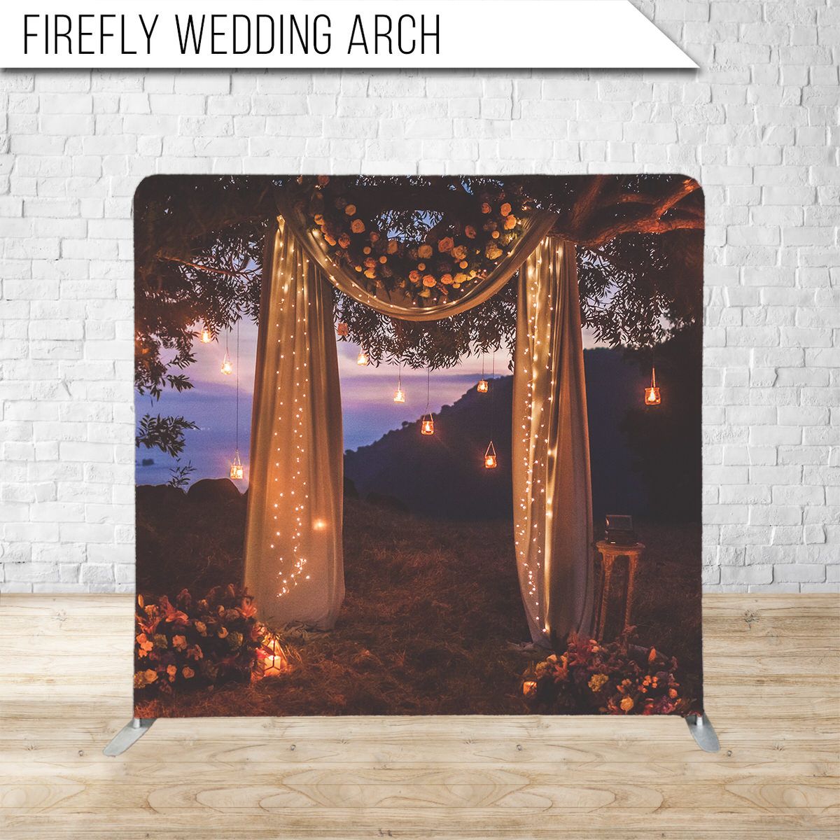 A romantic wedding arch decorated with flowing white fabric and twinkling string lights against a dusky evening sky.