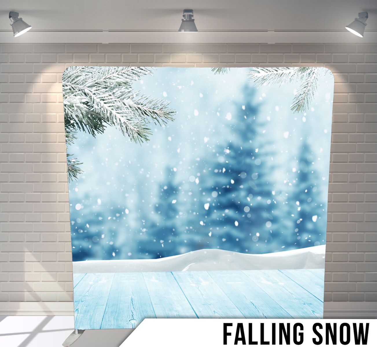 Photography backdrop with winter scene showing falling snow, pine trees and snowy ground against a bright sky.