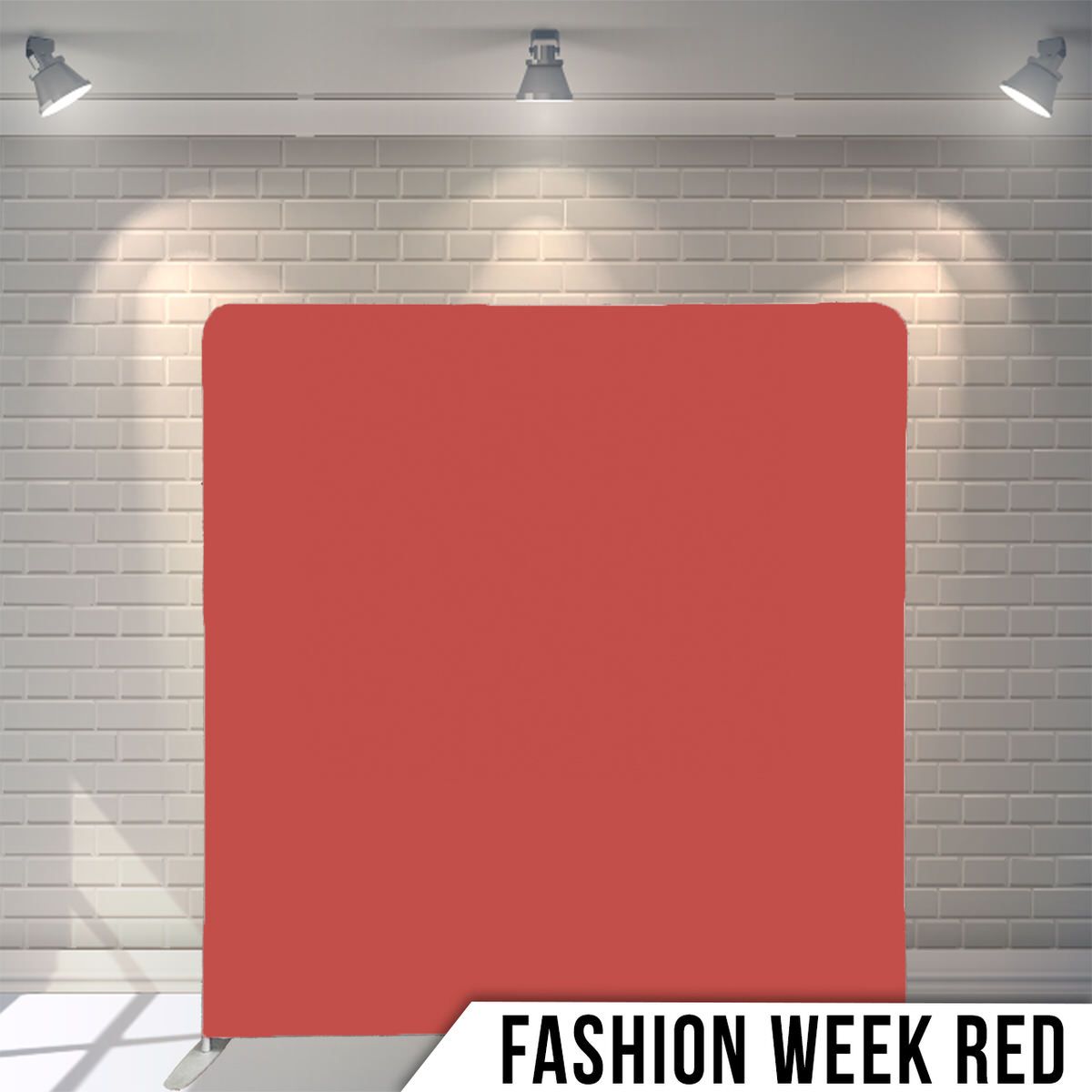 Red photography backdrop against white brick wall with spotlights casting dramatic shadows in studio setting.