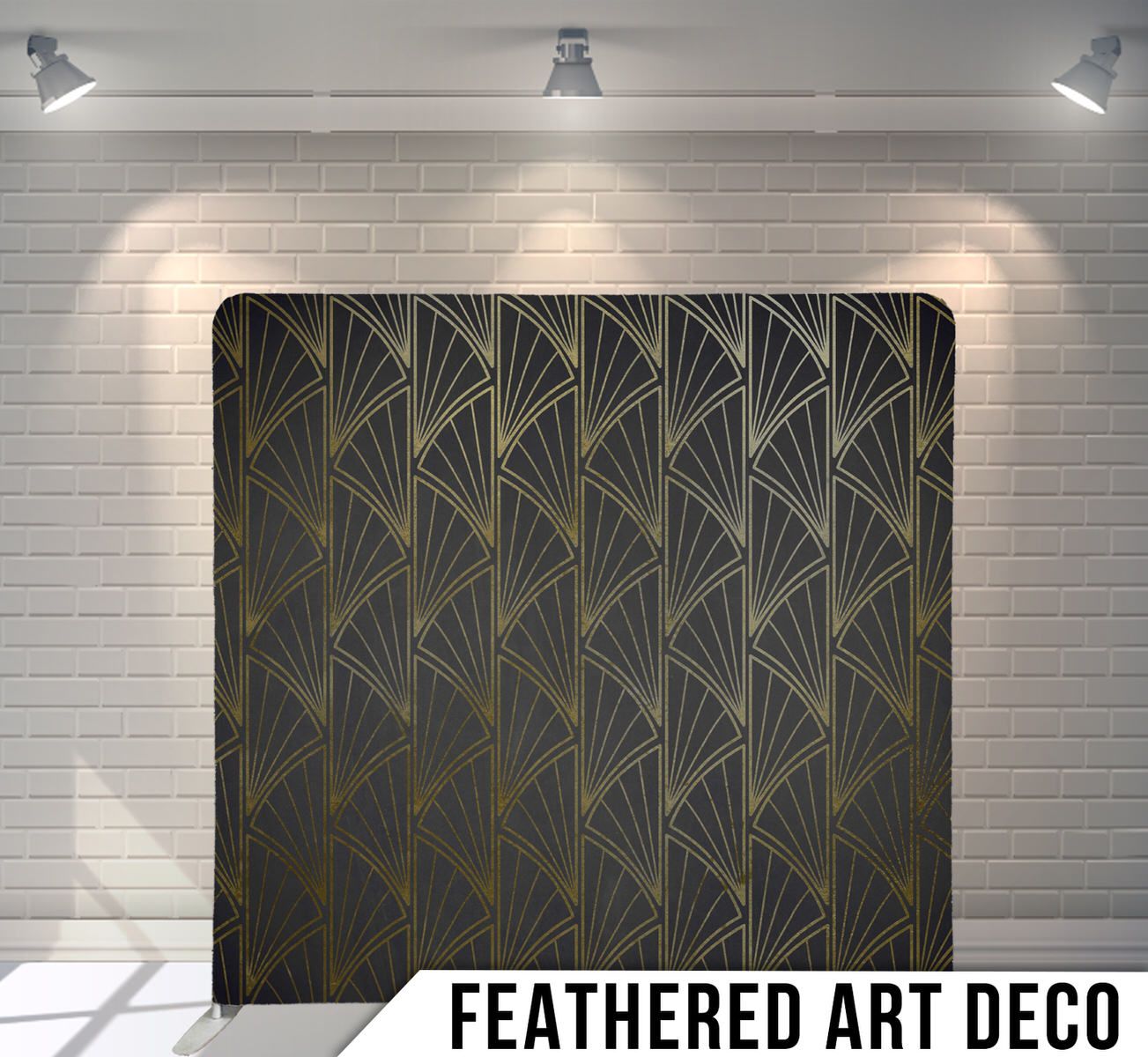 An Art Deco style black and gold feathered pattern backdrop illuminated by three spotlights against white brick wall.