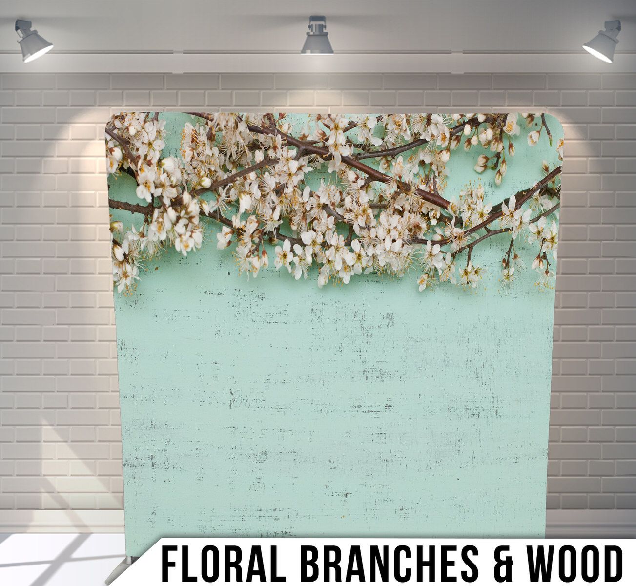 Spring cherry blossom branches with white flowers against a soft mint green textured backdrop displayed on gallery wall.