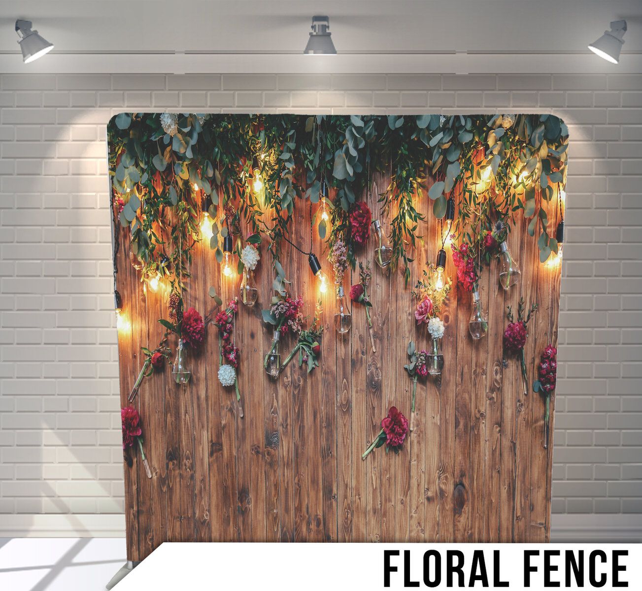 Rustic wooden fence backdrop with hanging floral arrangements and warm string lights creating a romantic ambiance.