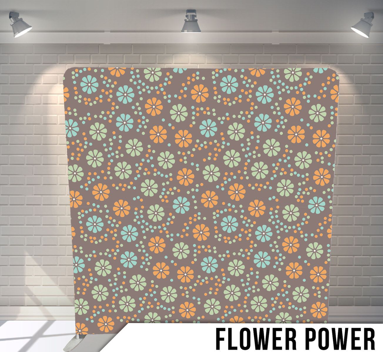Floral pattern backdrop featuring repeating blue and orange flowers on a brown background with studio lighting.