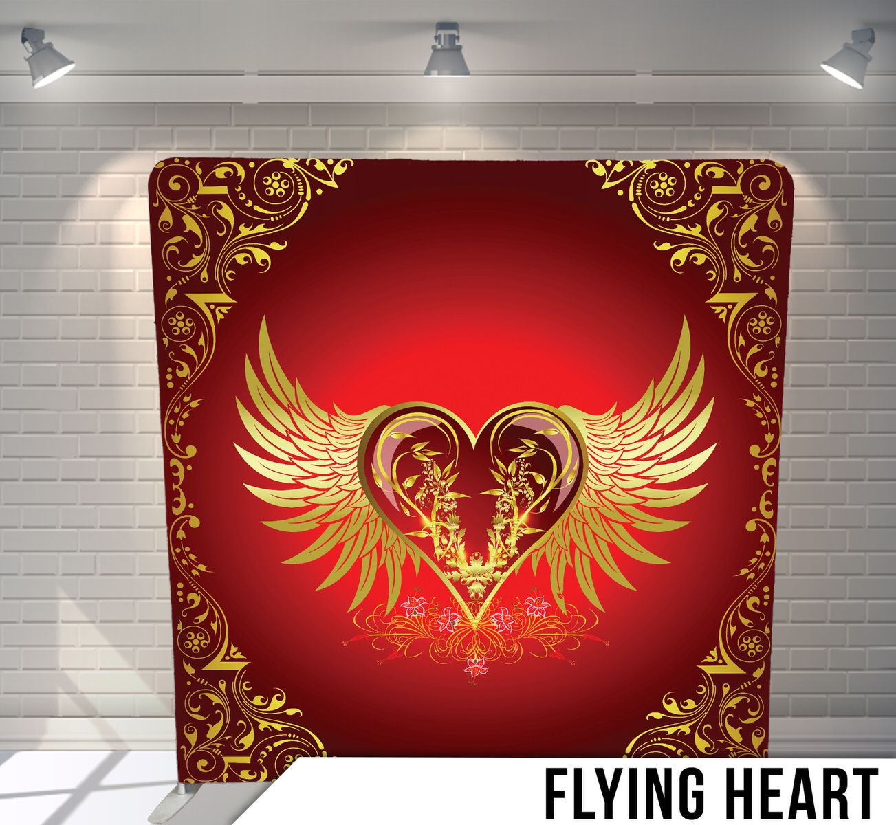 Decorative gold winged heart design on red background with ornate flourishes and spotlight illumination.