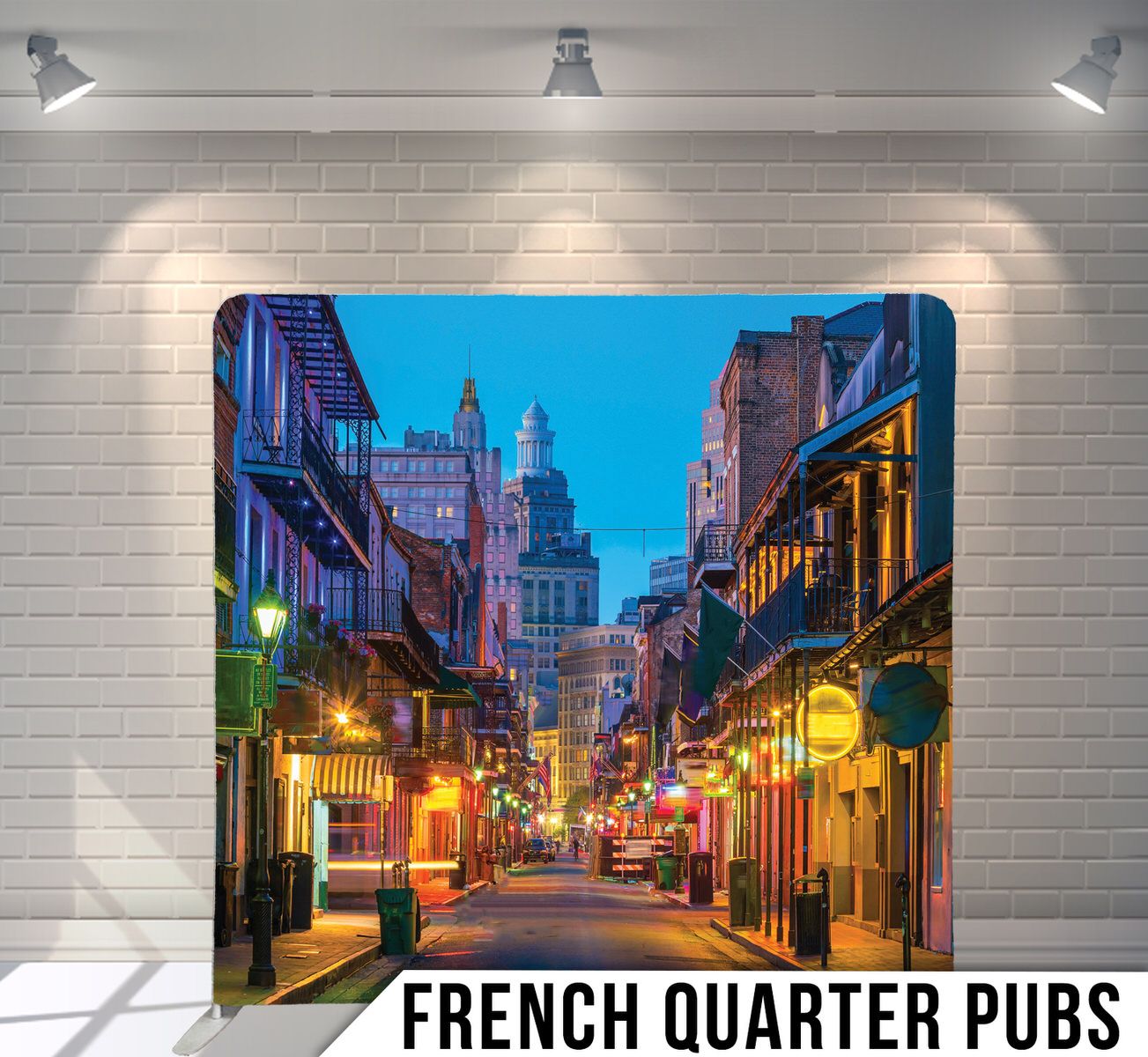 Illuminated French Quarter street in New Orleans with historic buildings and city lights.