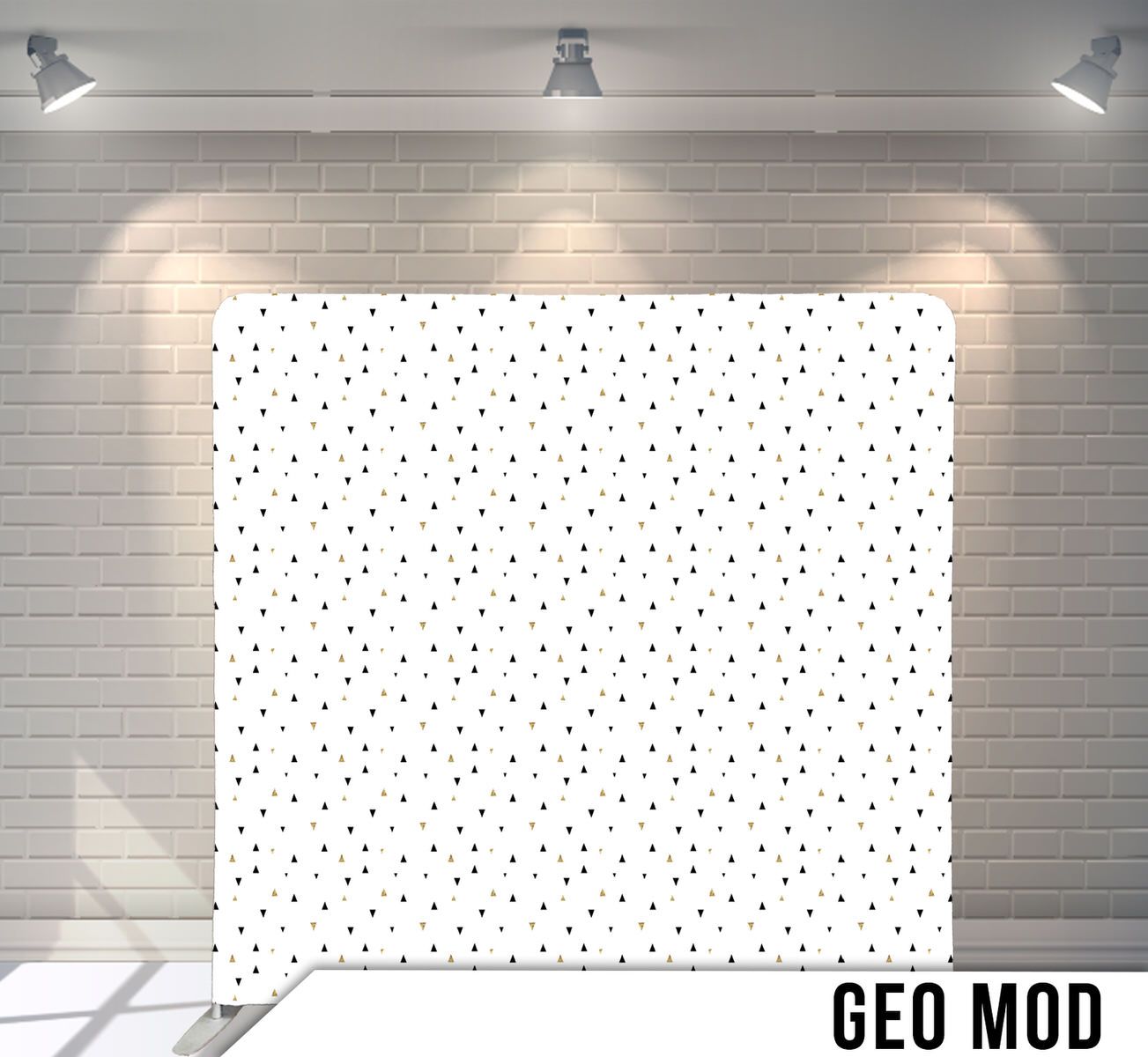 Simple scattered polka dot pattern on white background displayed against brick wall.