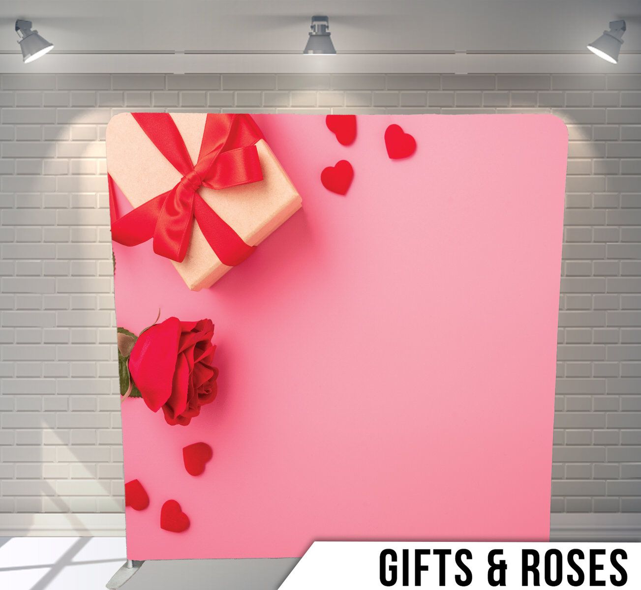 Pink backdrop with red gift box, rose, and heart decorations in corner composition.