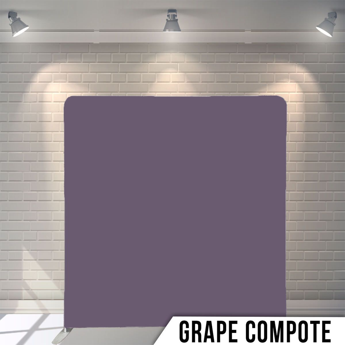 Studio backdrop in grape purple color with overhead spotlights illuminating the surface.