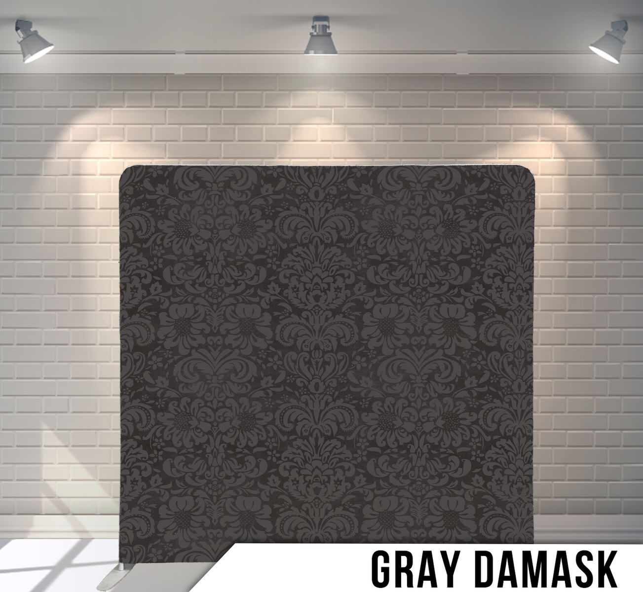 Dark gray damask pattern backdrop with ornate floral designs under studio lights.