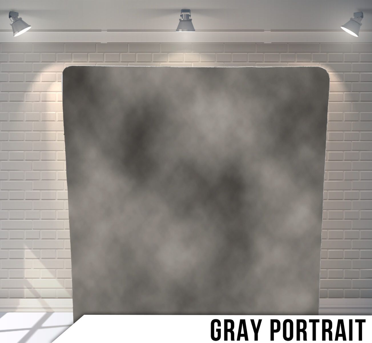Gray misty backdrop with shadowy gradient effect against a white brick wall.