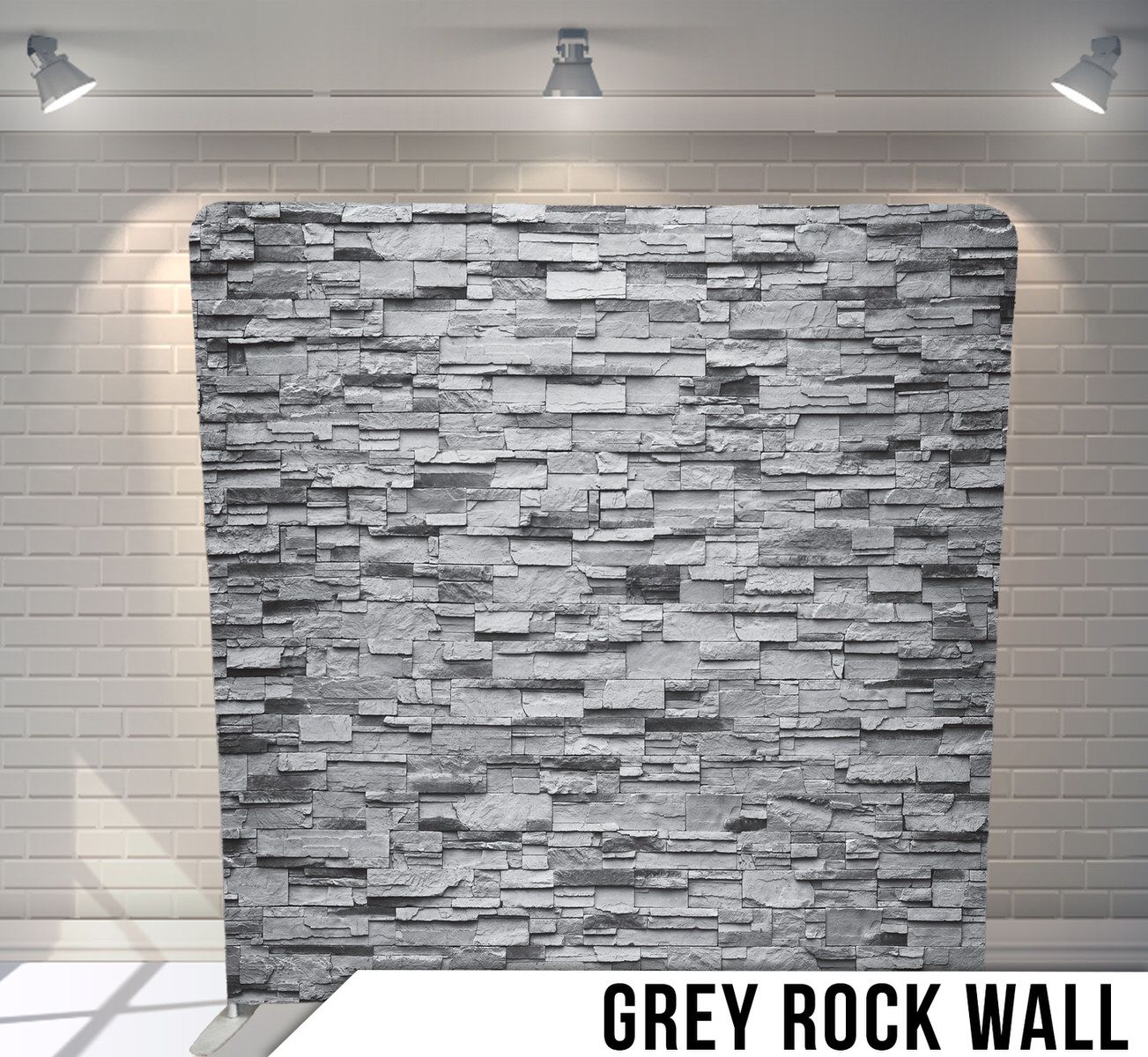 Textured grey stone wall backdrop with stacked ledger panels.