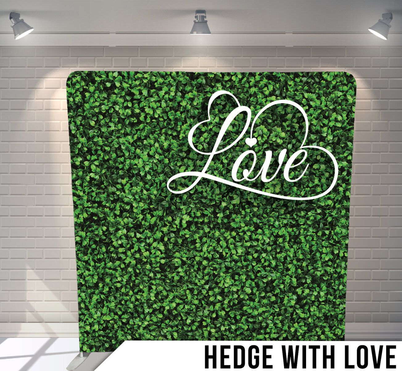 Green hedge wall backdrop with white cursive 'Love' text decoration.