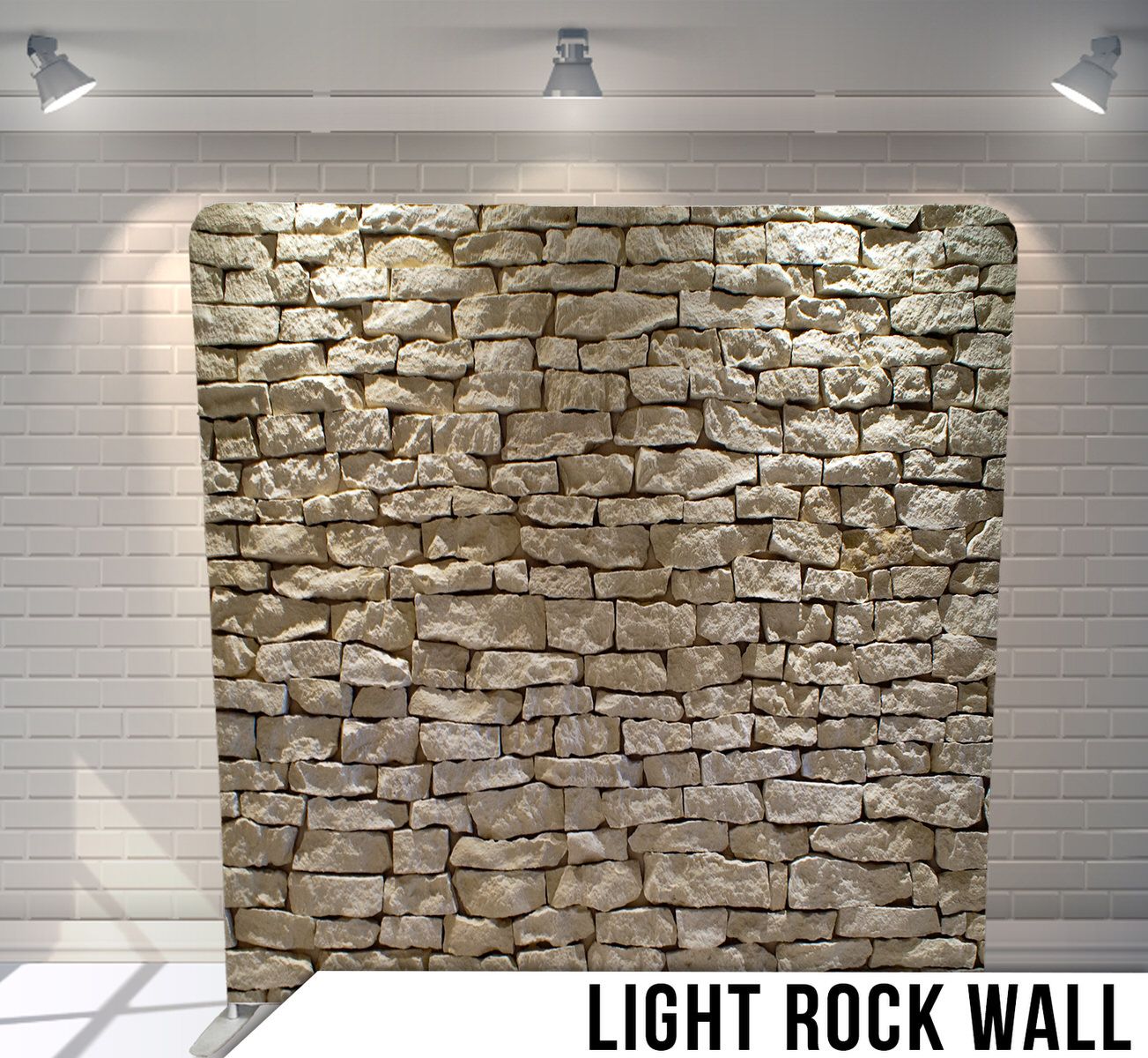 Illuminated rustic stone wall backdrop with textured grey and tan rock patterns.