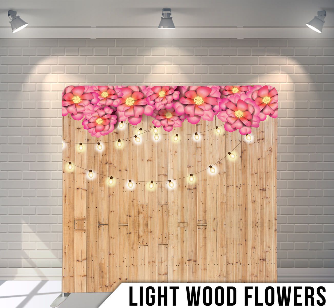 Light wooden backdrop decorated with pink flowers and hanging string lights for events.