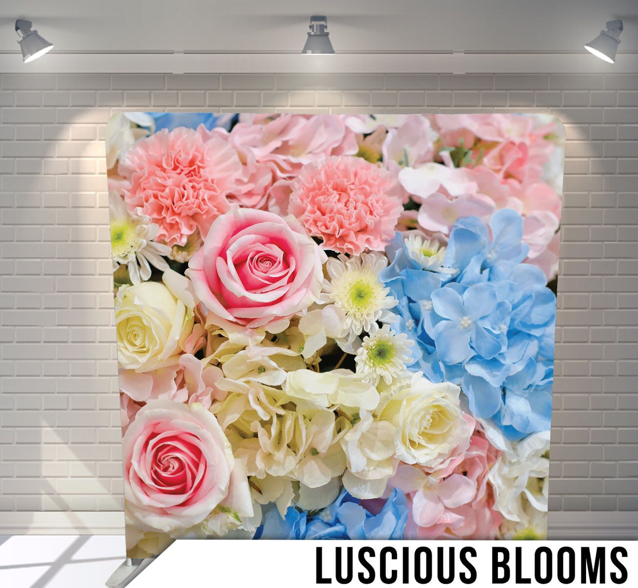 Pastel floral arrangement with roses, carnations, and hydrangeas in soft pink and blue tones.