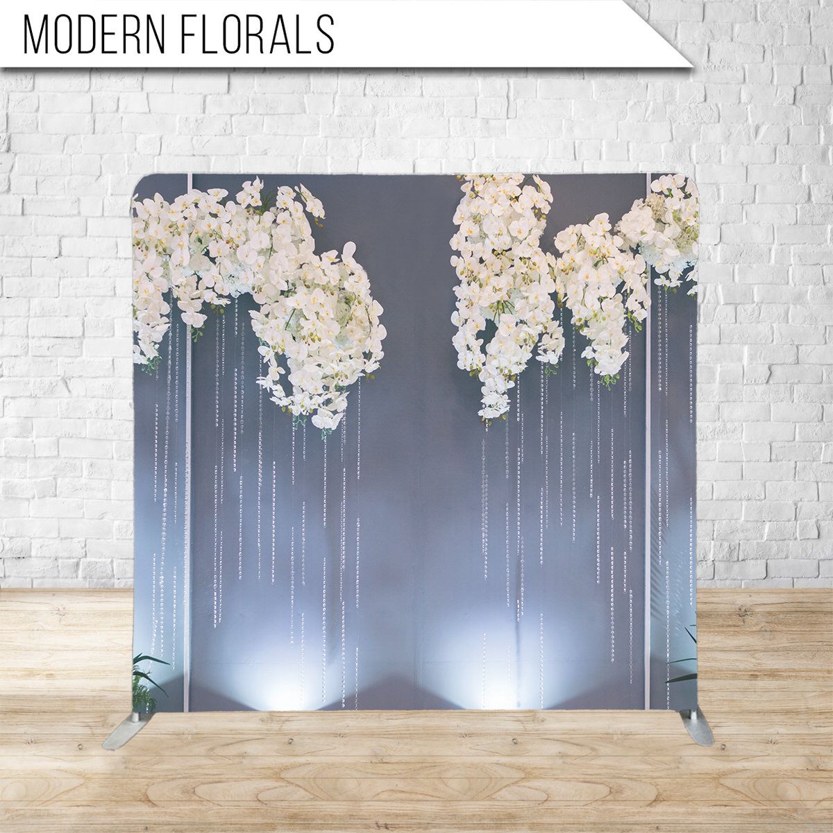 Modern floral display featuring cascading white blooms illuminated from below against a dark background.