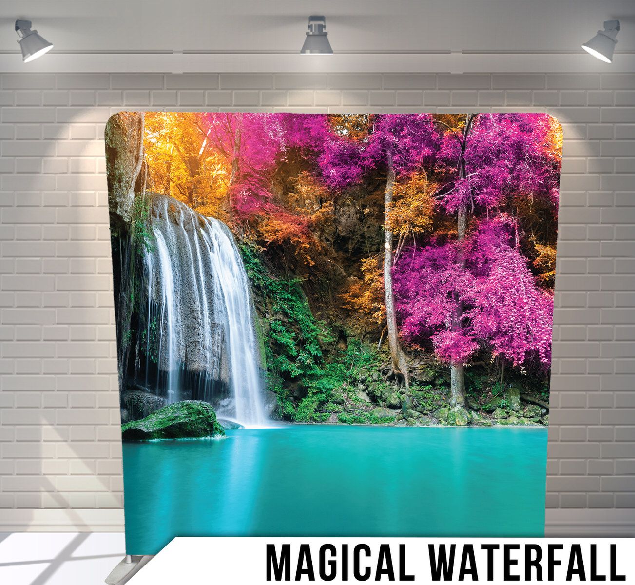 Stunning tropical waterfall with turquoise pool surrounded by trees with vibrant pink and orange foliage.