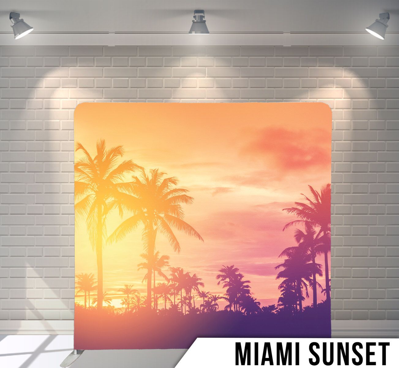 Tropical palm tree silhouettes against vibrant orange and pink sunset sky.