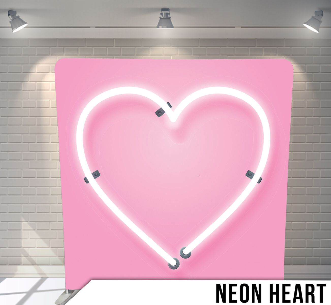 Pink neon heart light fixture mounted on pink background with studio lighting.