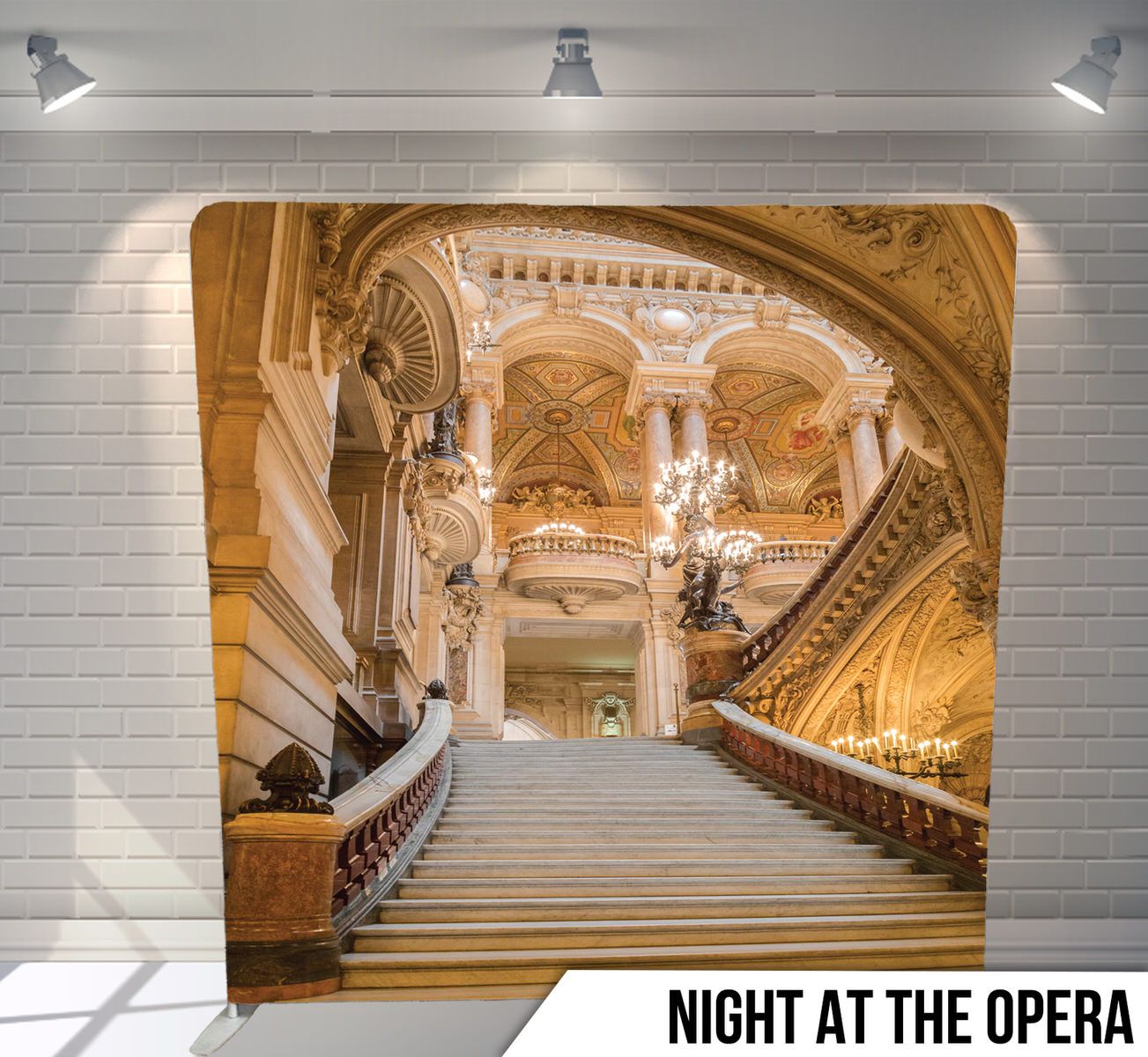 Ornate gold opera house interior featuring grand marble staircase and classical architectural details.