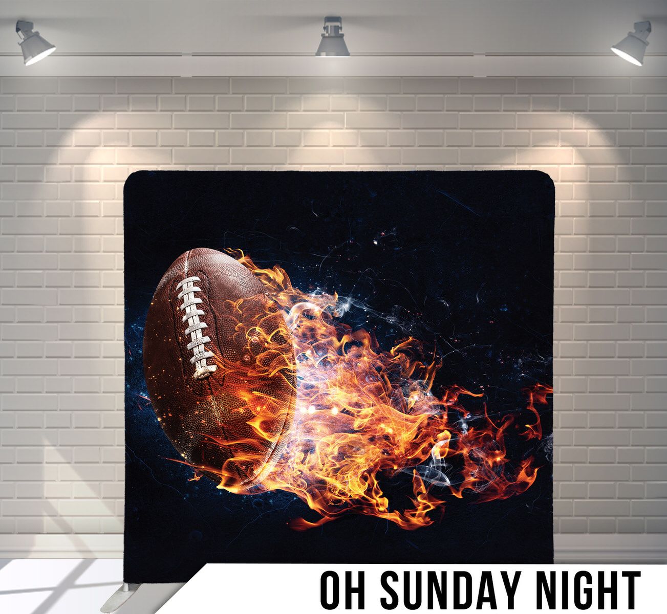 American football engulfed in dramatic flames against black background.