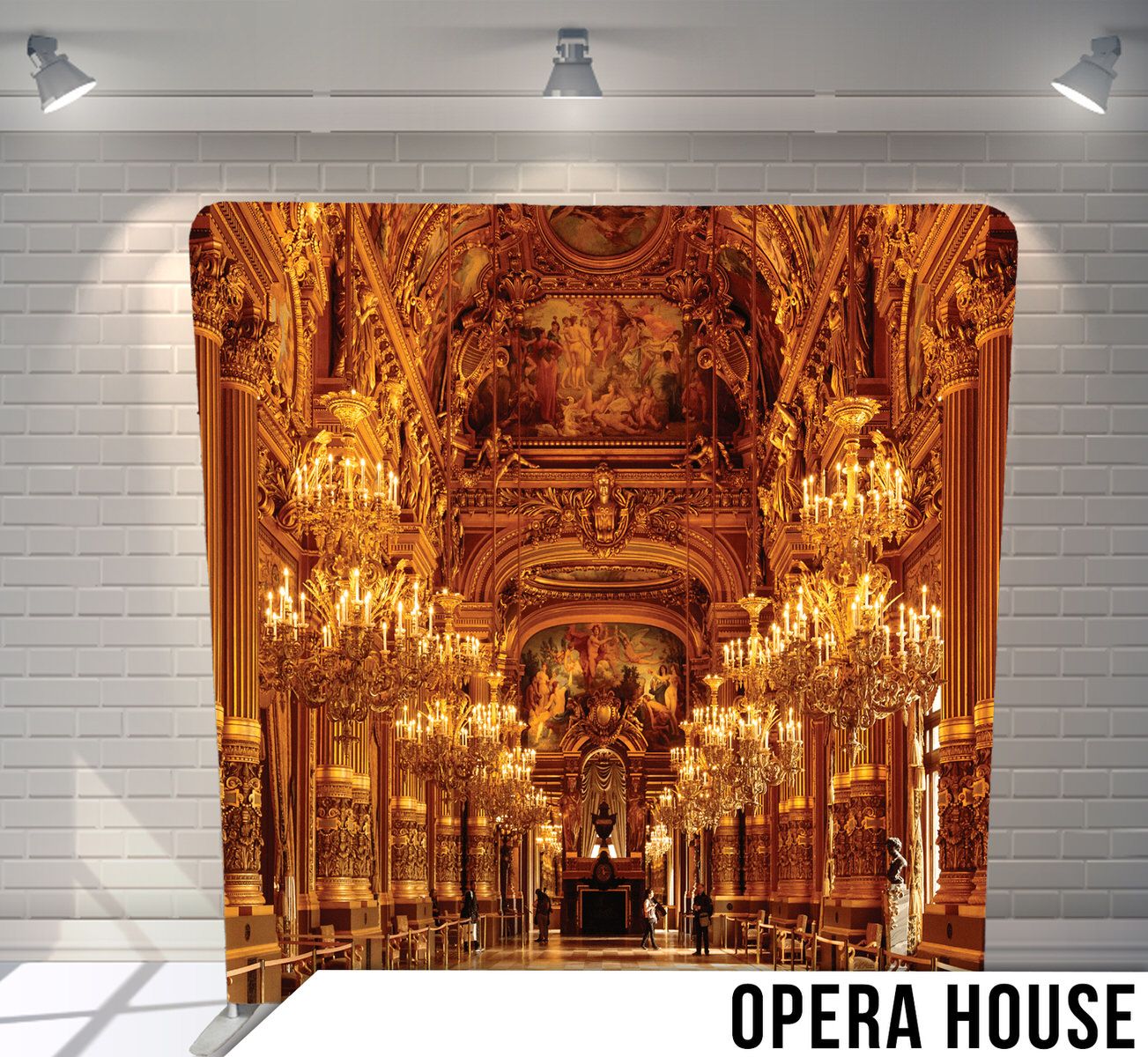 Ornate golden opera house interior with crystal chandeliers and baroque architectural details.