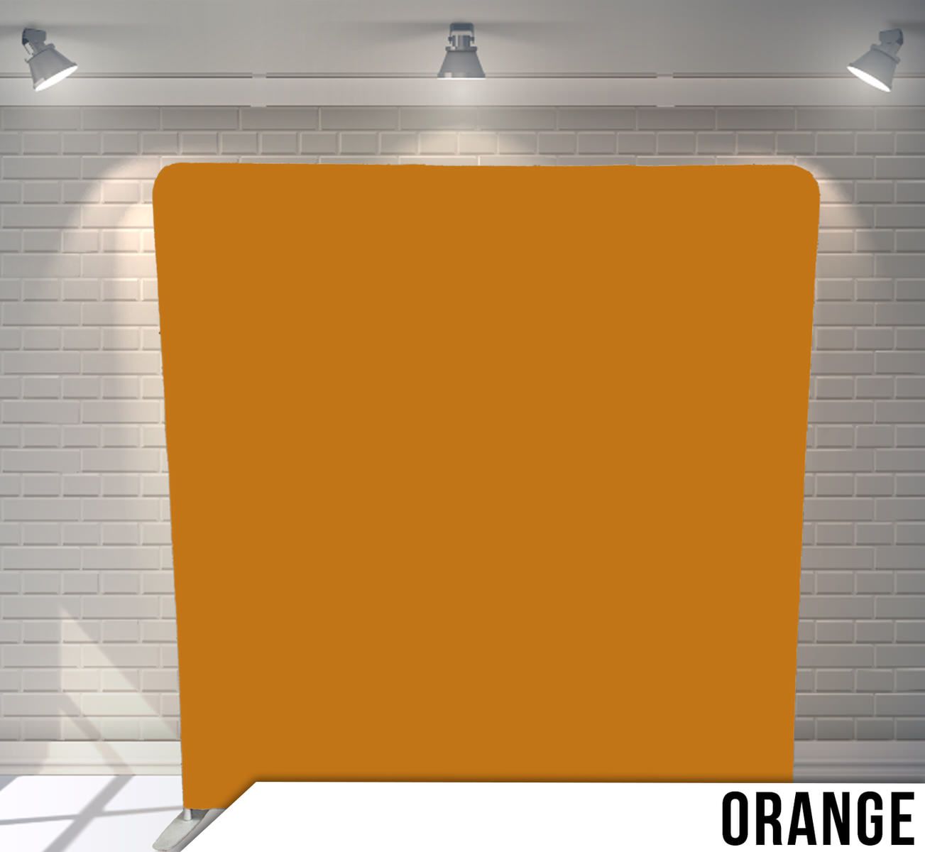 Solid orange colored backdrop panel against white brick wall with studio lighting.