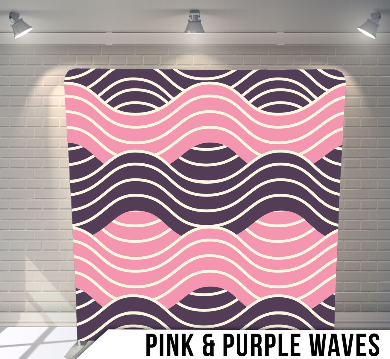 Pink and purple wavy lines forming a repeating geometric pattern on a backdrop with studio lighting.