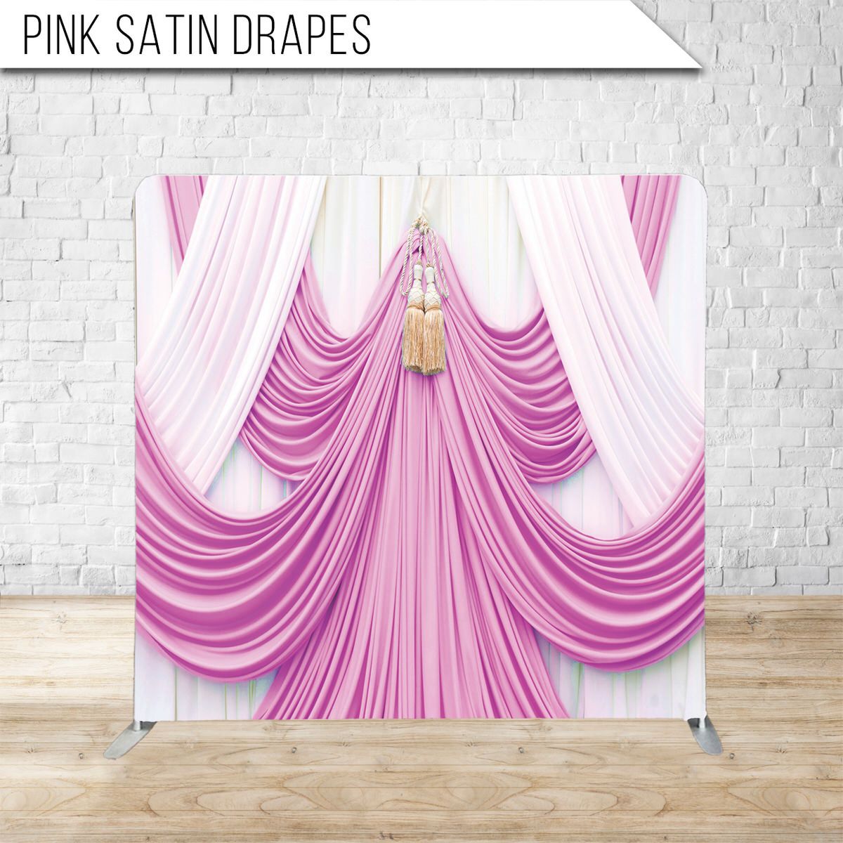 Elegant pink satin drapes arranged in sweeping curves with dramatic lighting on white backdrop.