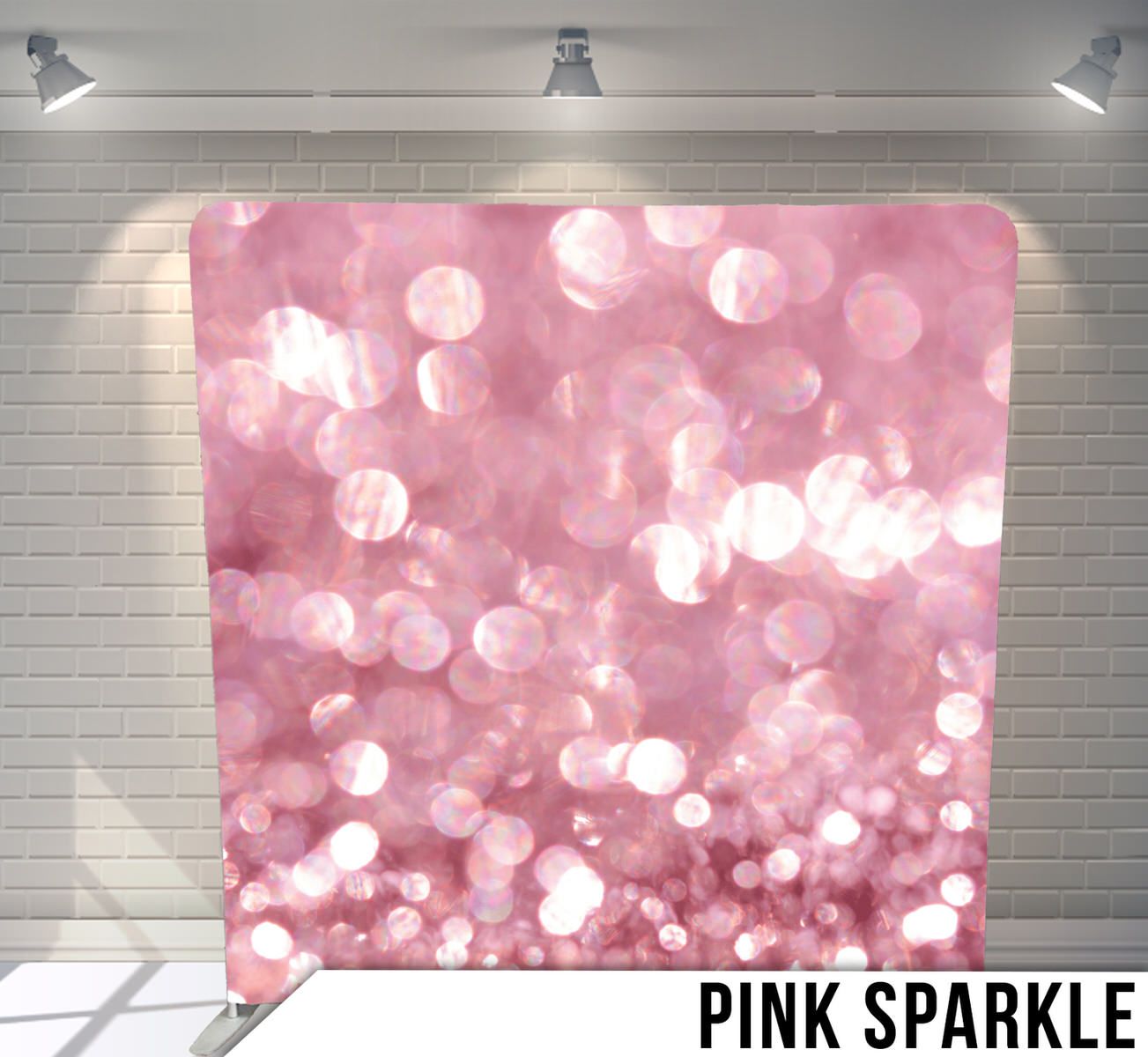 Dreamy pink bokeh background with glittering light effects under studio lighting.