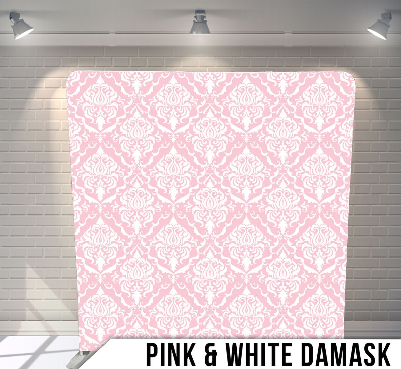 Classic damask pattern in pink and white displayed on photography backdrop.