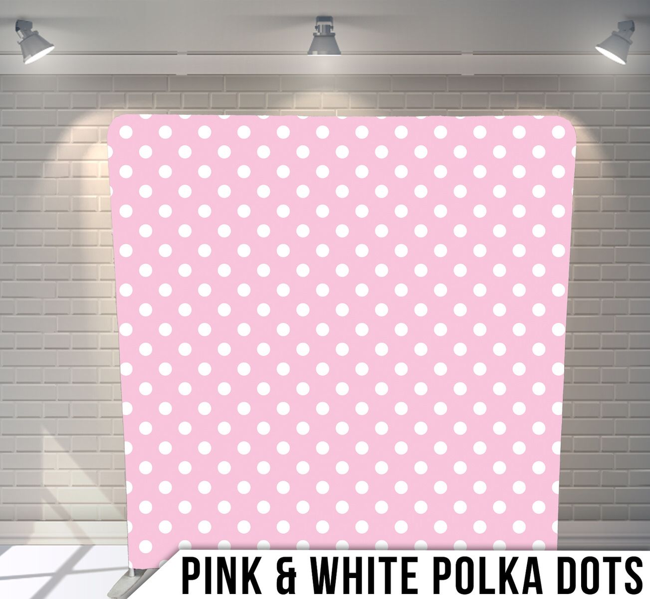Sweet pink background with white polka dots pattern under studio lighting.