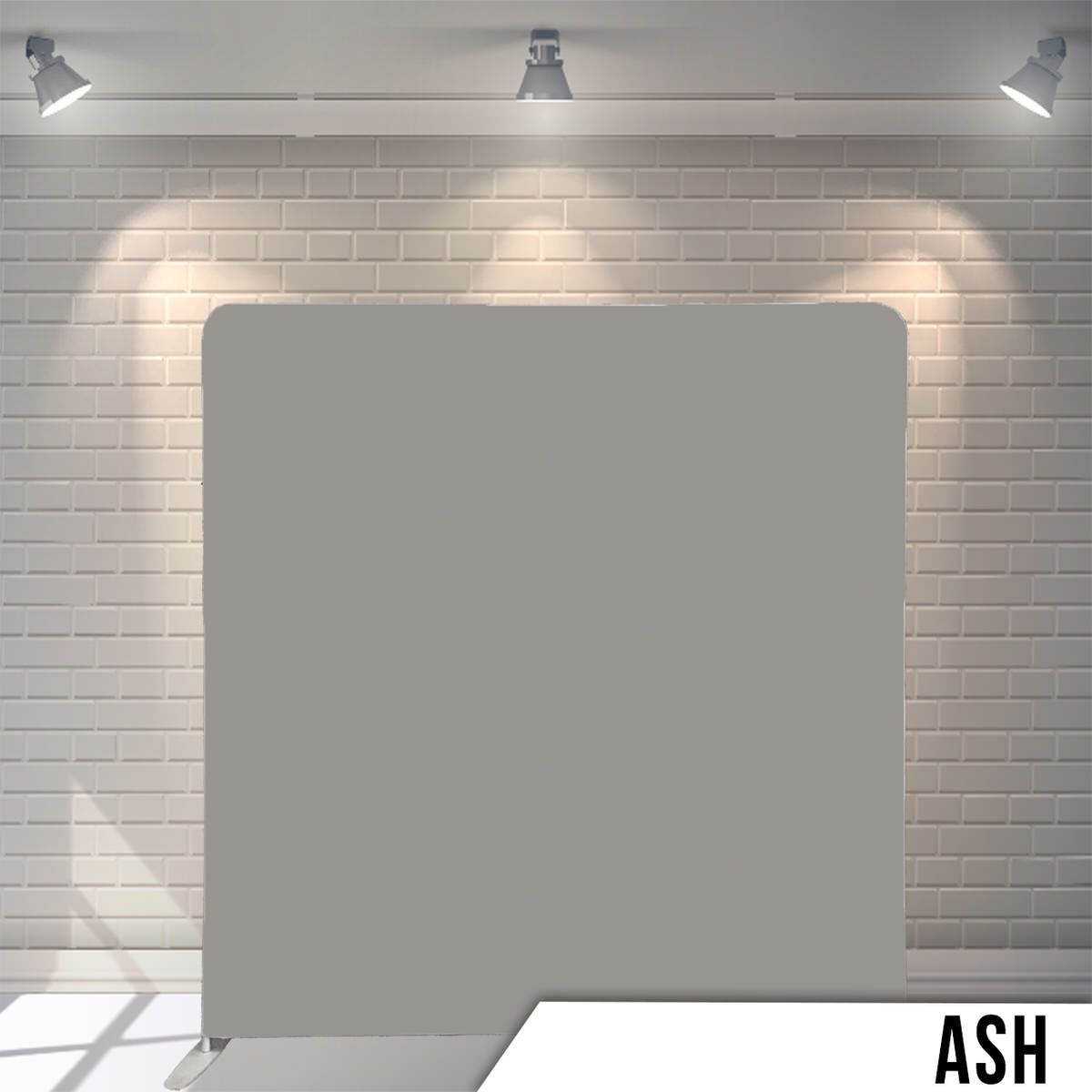 Plain ash gray backdrop displayed against white brick wall with studio lighting.