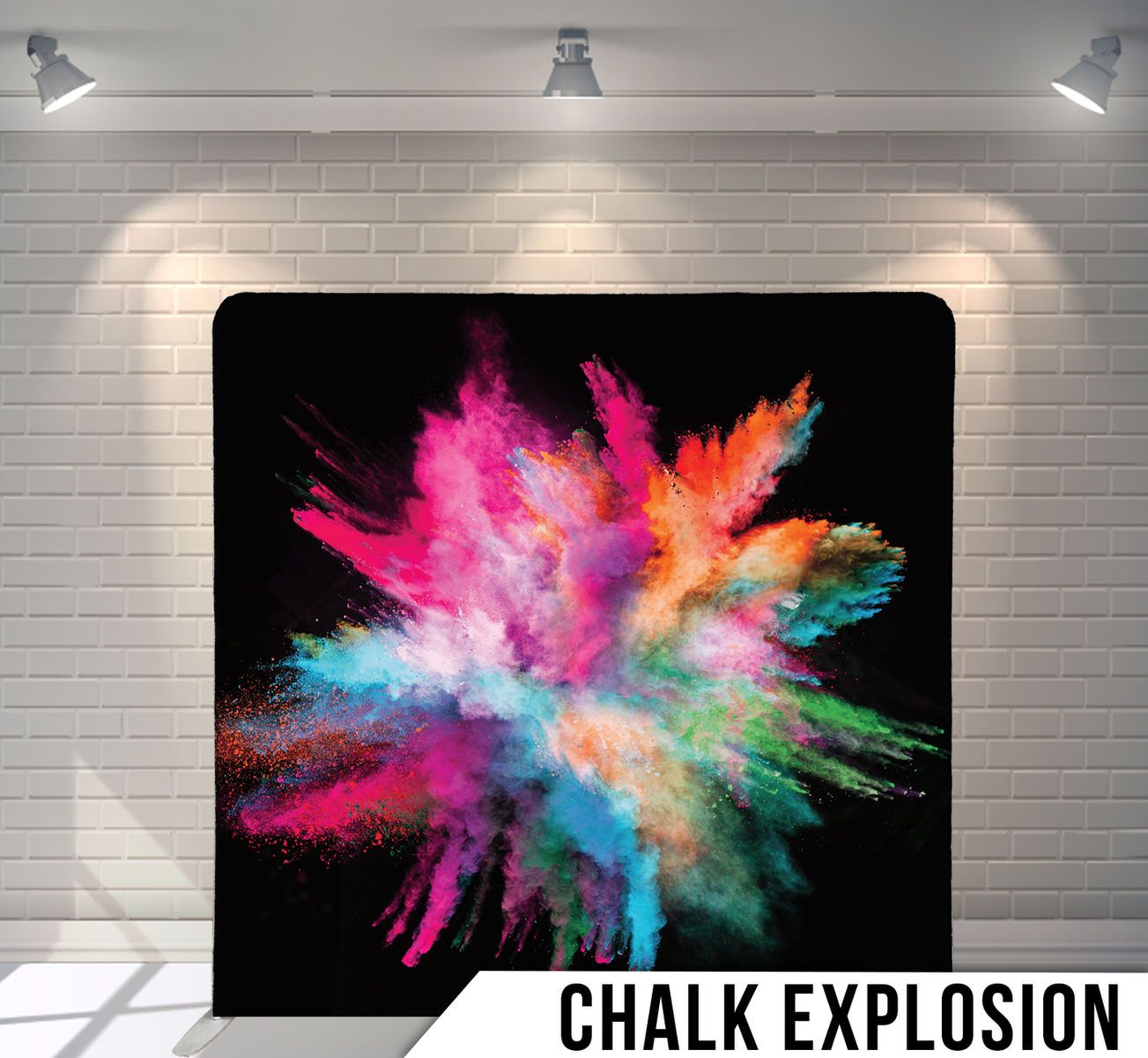 Colorful powder explosion in pink, orange, blue and green against black background.