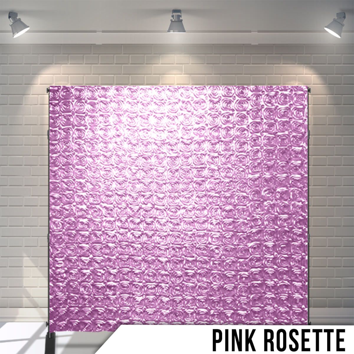 Textured pink rosette pattern backdrop with dimensional flower-like shapes under studio lights.