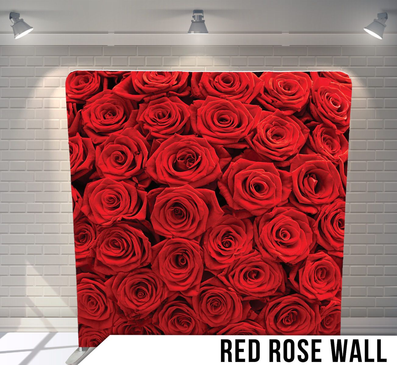 Backdrop of densely packed fresh red roses creating seamless floral wall.