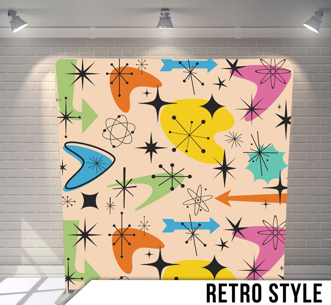 Colorful mid-century modern pattern with atomic starbursts and arrows on cream background.