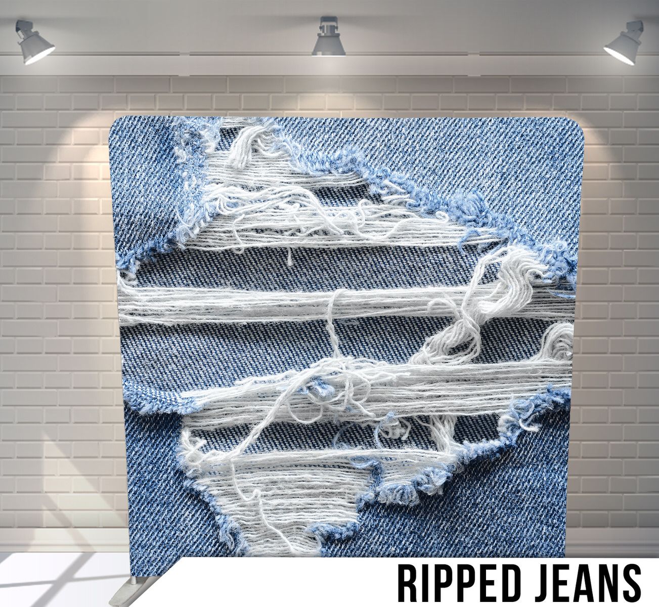 Close-up of distressed denim fabric with white frayed threads and ripped texture.