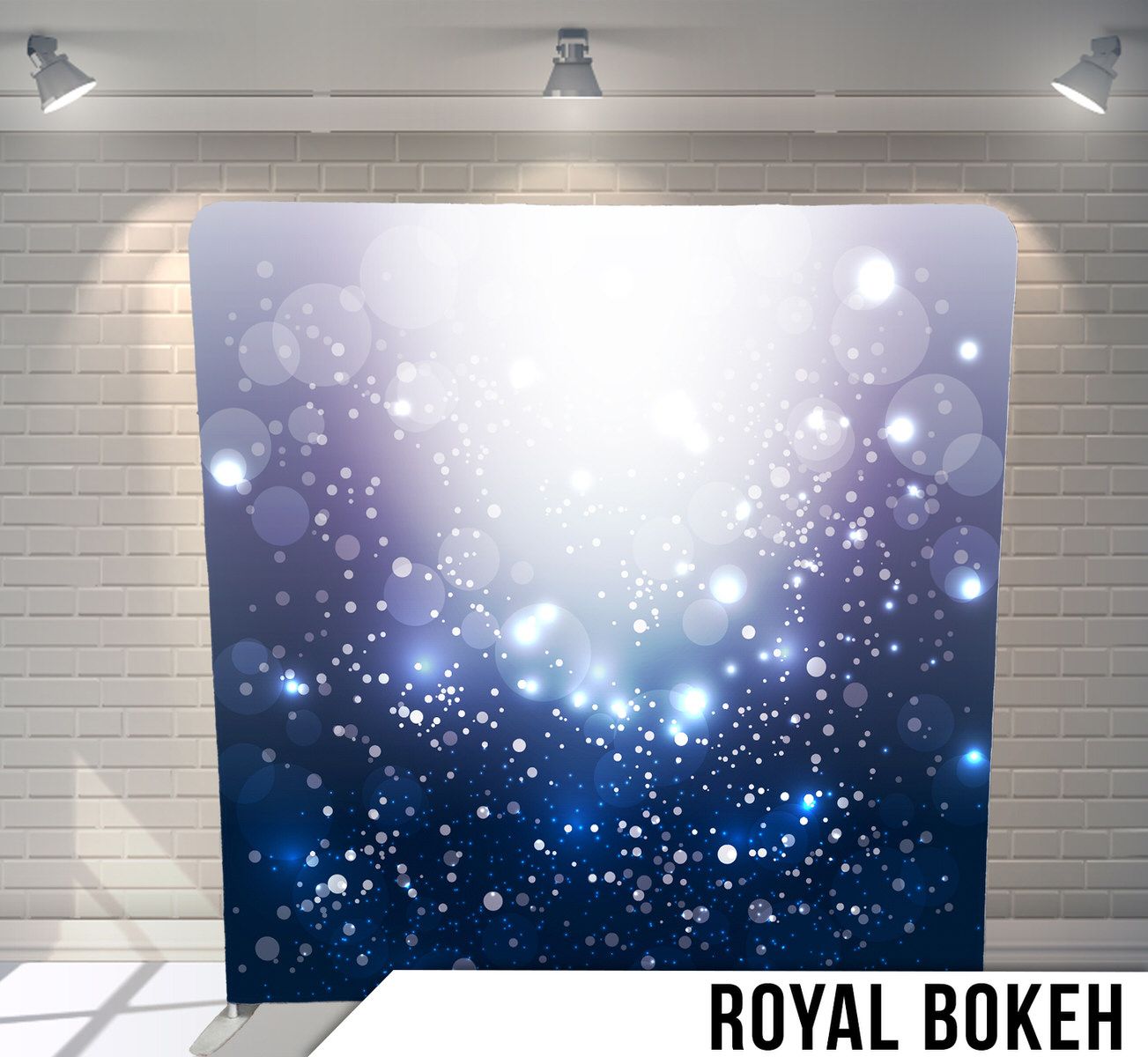 Dreamy blue bokeh effect backdrop with sparkling light particles for magical photo settings.