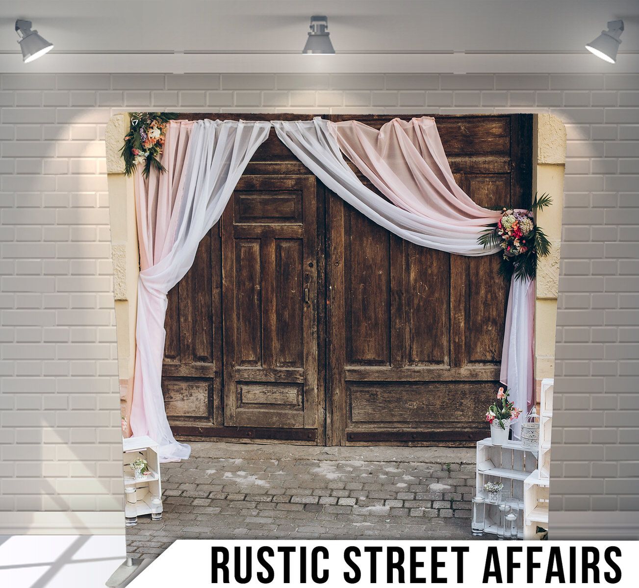 Rustic wooden doors with draped white and pink fabric panels and lantern decorations.