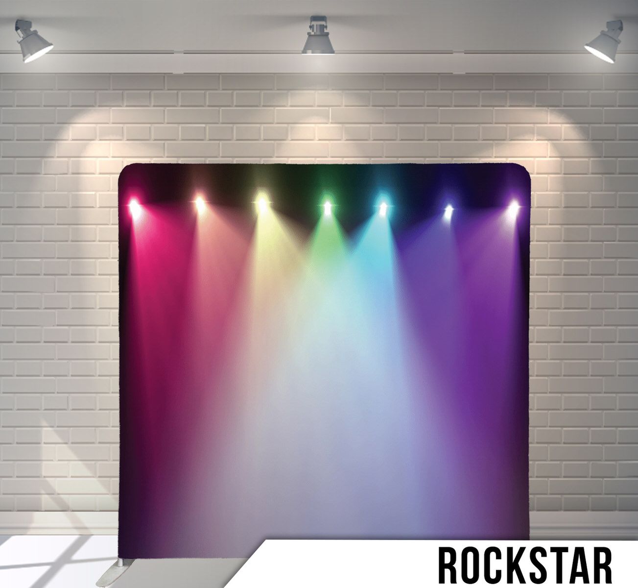 Rainbow colored stage lights create a vibrant multicolor gradient effect against a white backdrop.