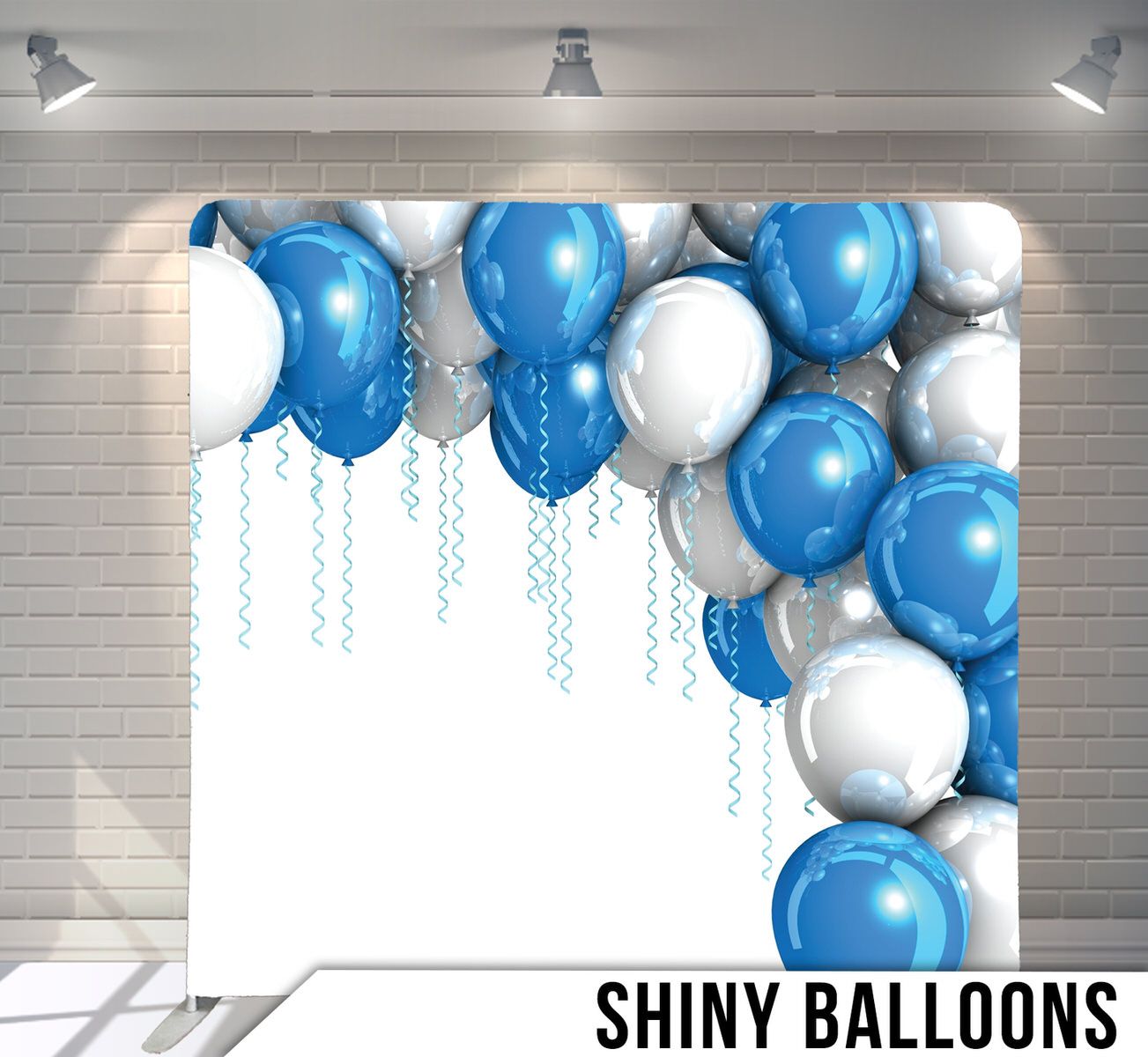 Blue and white balloons arranged in corner formation with dangling ribbons against white background.