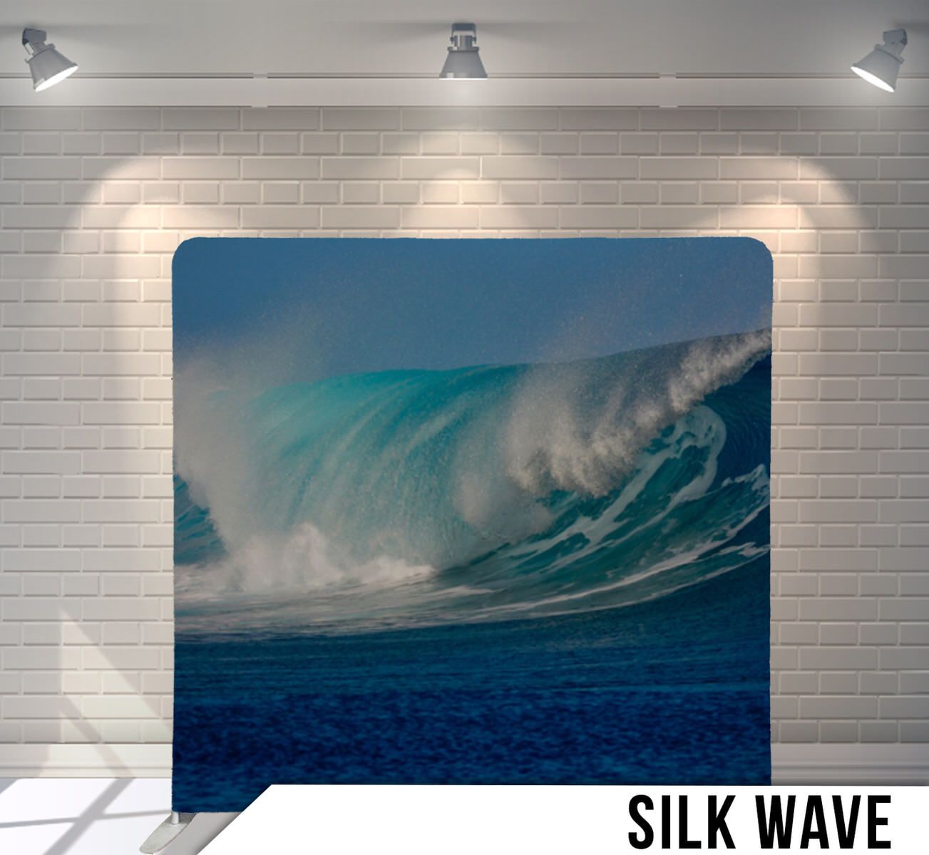 Massive turquoise ocean wave cresting against blue sky background.