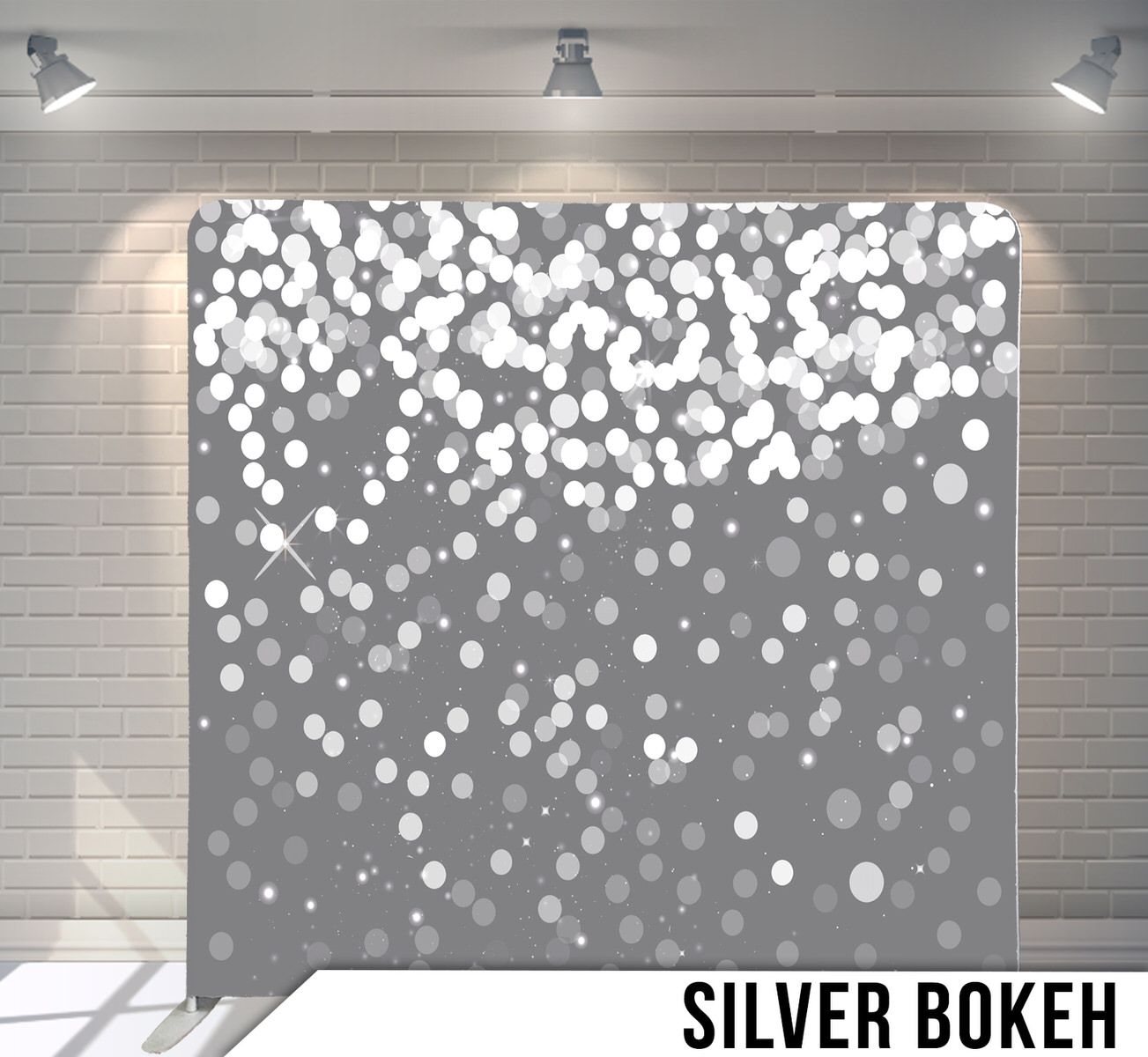 Silver bokeh light effects scattered on dark gray gradient background.