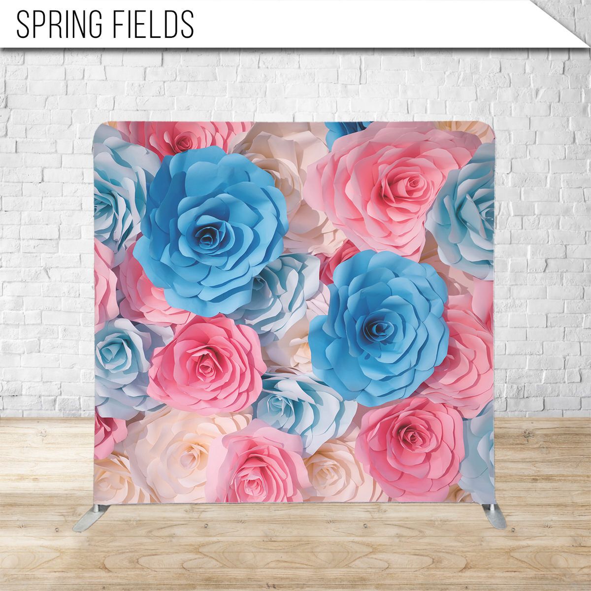 Paper roses in pink and blue colors arranged in decorative backdrop pattern.