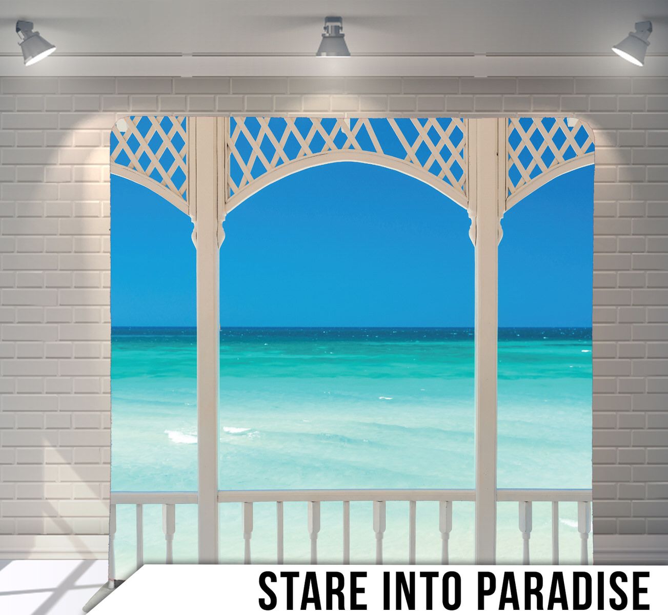 Tropical beach view through white Victorian-style porch frame with turquoise ocean waters.